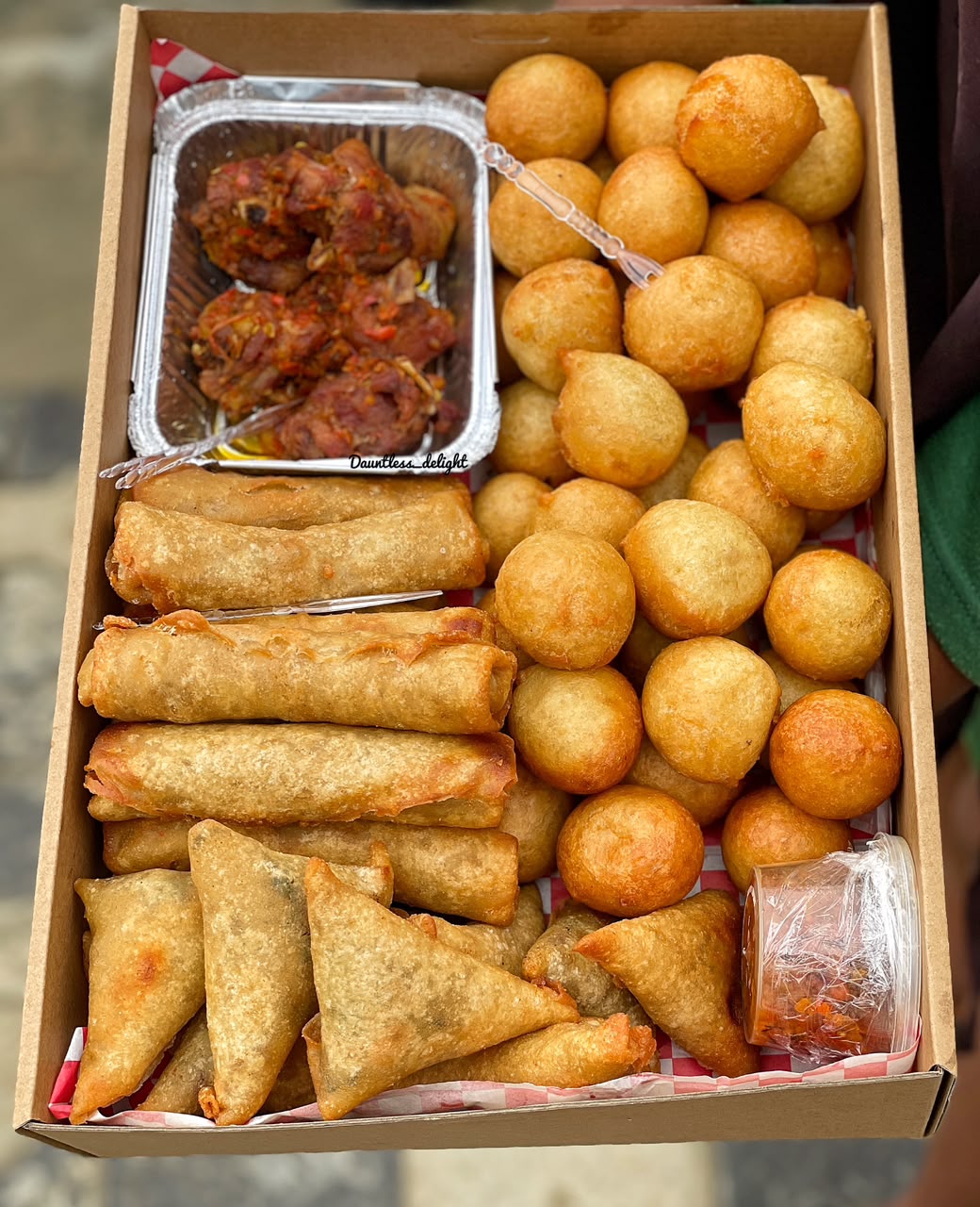 Large small chops box with puff-puff, spring rolls, samosas, peppered chicken and dipping sauce