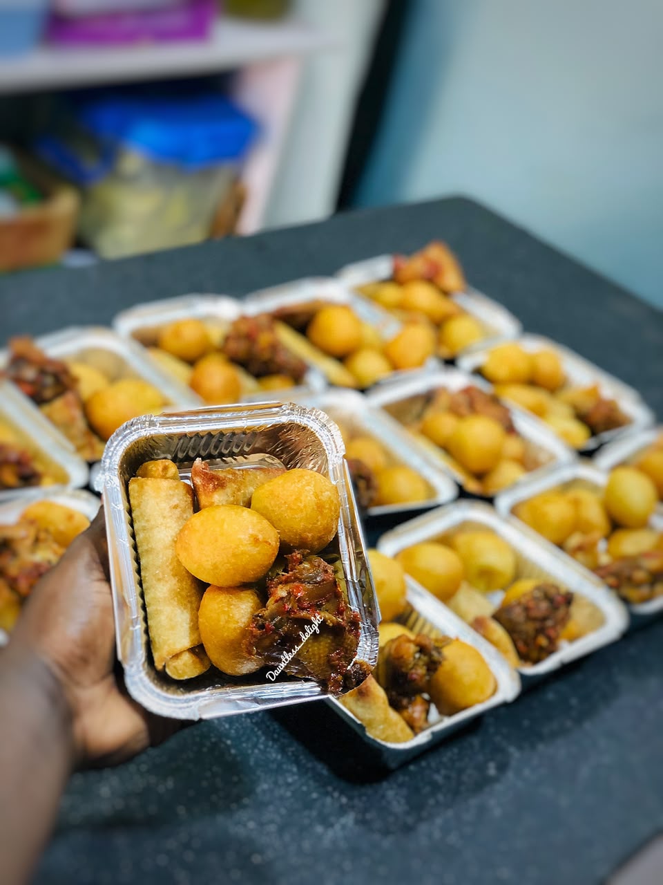 Individual small chops packs with puff-puff, spring rolls and peppered chicken