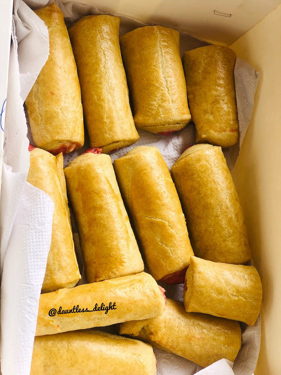 Tray of golden sausage rolls fresh from the oven