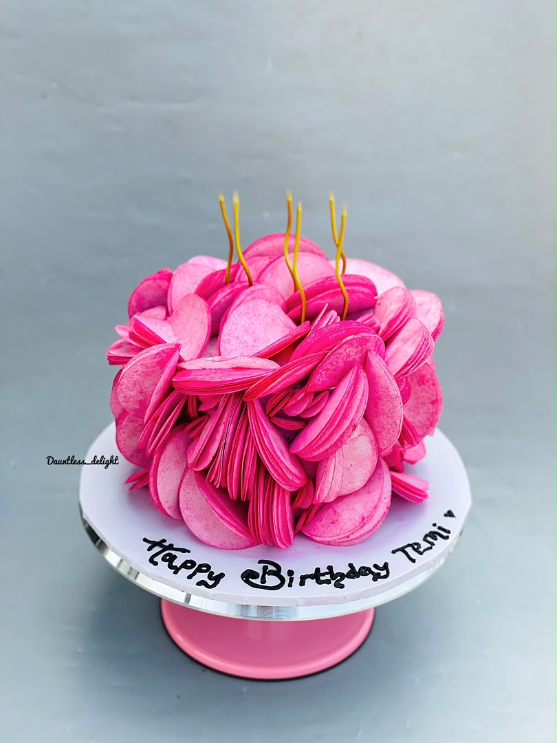 Hot pink macaron style birthday cake with candles