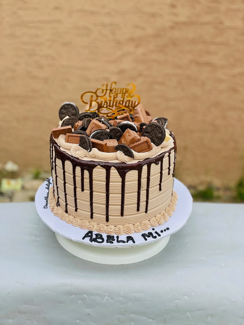 Chocolate drip birthday cake topped with Oreos and chocolate bars