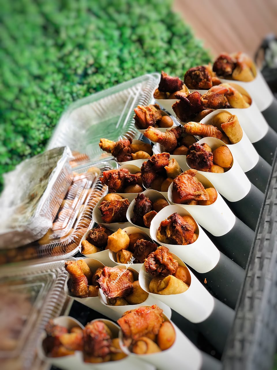 Rows of small chops cones with puff-puff and peppered meat for event catering