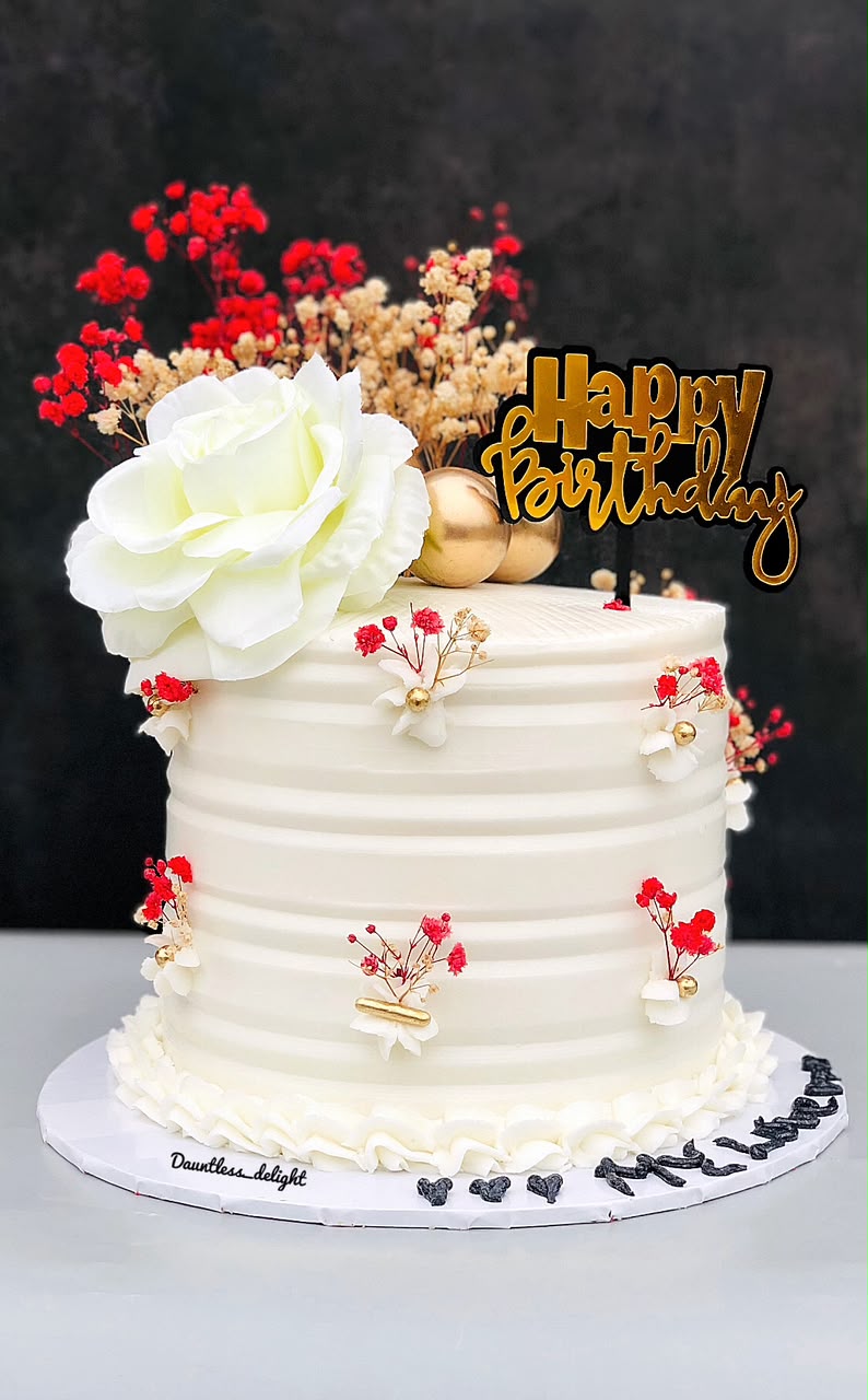 White textured birthday cake with red baby's breath and white rose